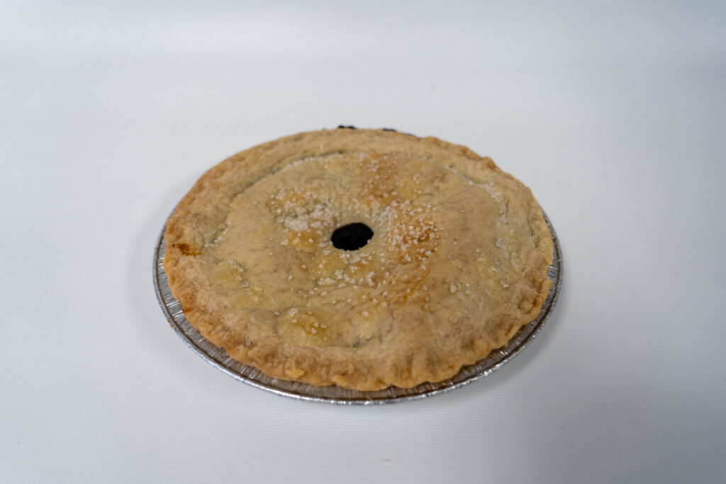Classic Blueberry Pie with a golden, flaky crust and a rich, bubbling blueberry filling, topped with a lattice design.