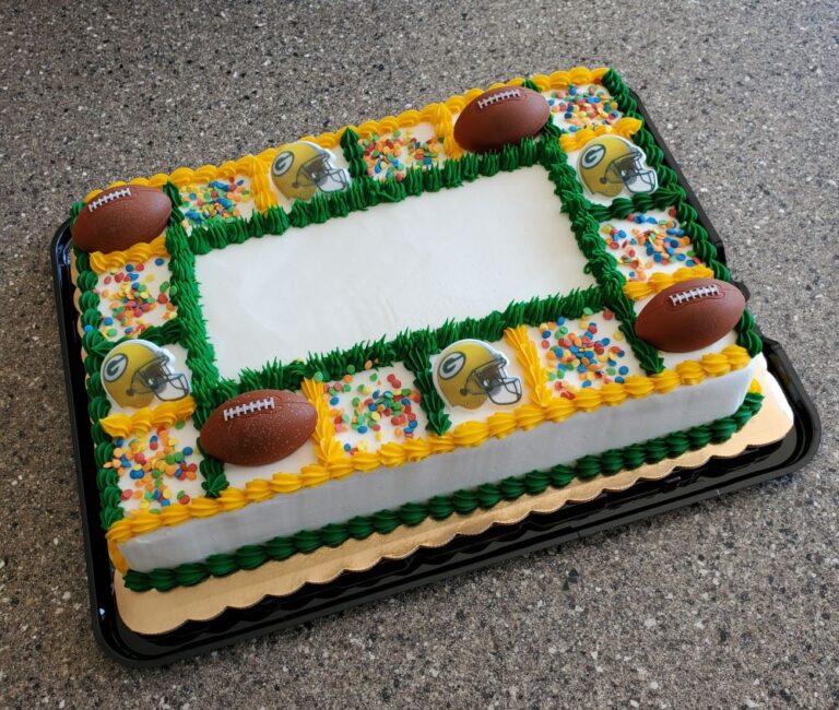 white frosted sheet cake with green and yellow frosting and packer NFL Football team decorations