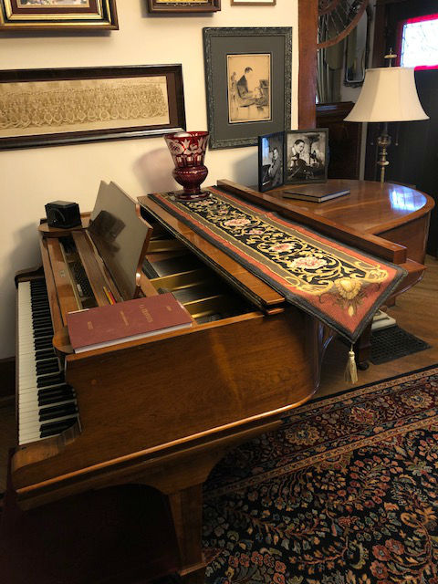French table runner on a piano