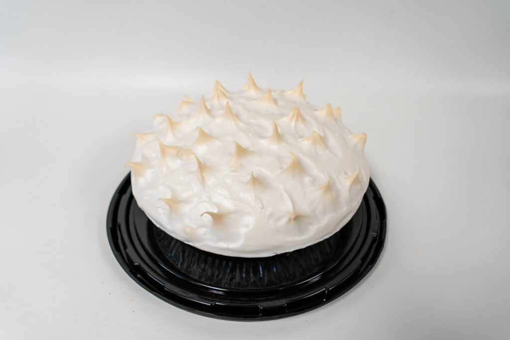Lemon Meringue Pie with a bright, tangy lemon filling and a tall, golden-browned meringue topping in a flaky pie crust.