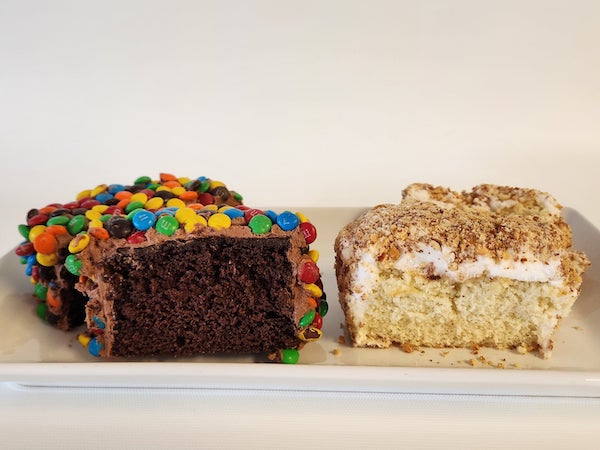 Mini cakes topped with peanuts and colorful M&M candies, featuring a soft cake base and festive, crunchy toppings.