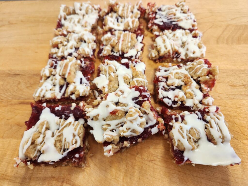 Raspberry Oatmeal Bars with a buttery oat crumble and vibrant raspberry filling, baked to a golden perfection.