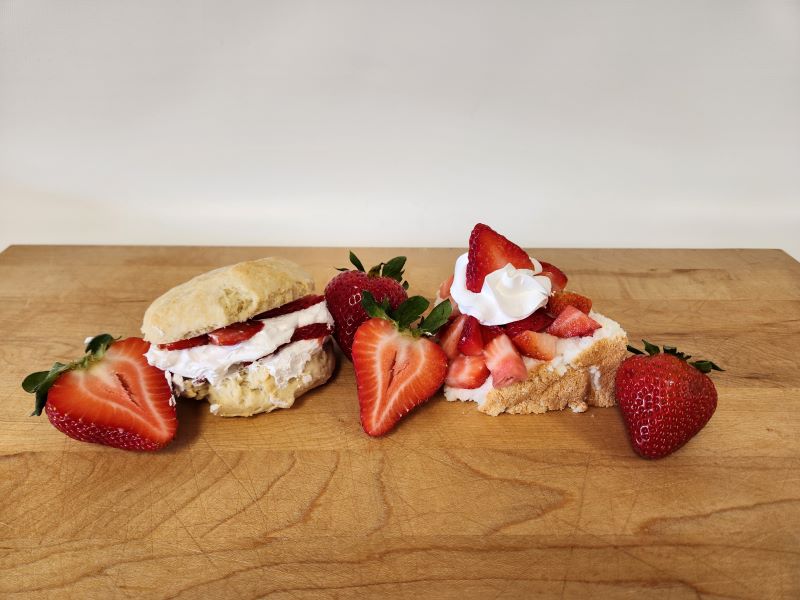 strawberry biscuit and shortcake desserts decoratively plated on a cutting board