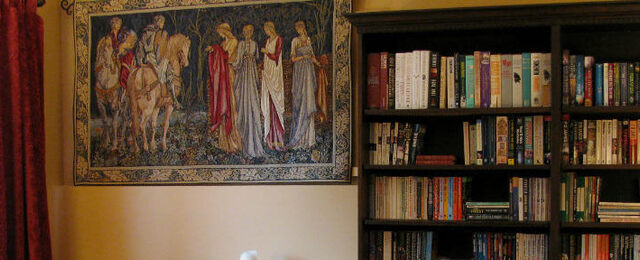 Tapestry hanging next to a bookcase