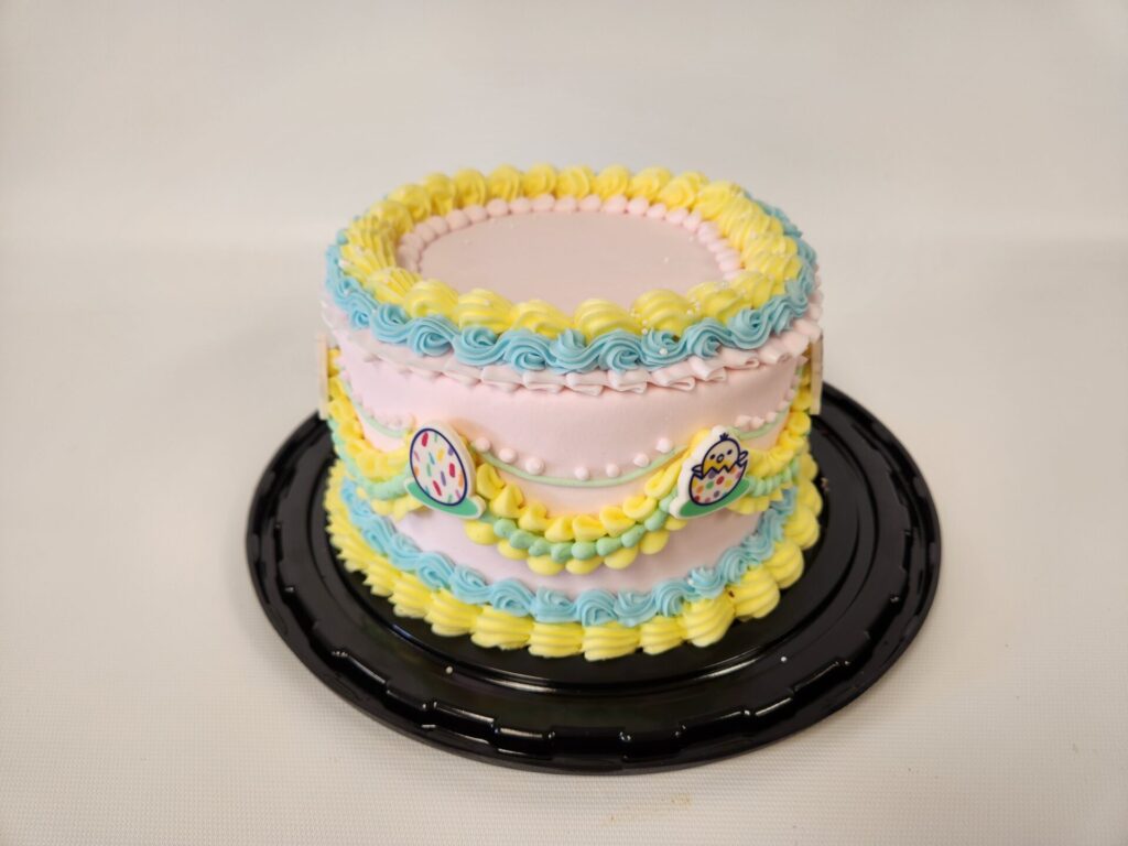 Vintage-style Easter cake with pastel-colored frosting and decorative piping, featuring soft spring hues and an old-fashioned charm.